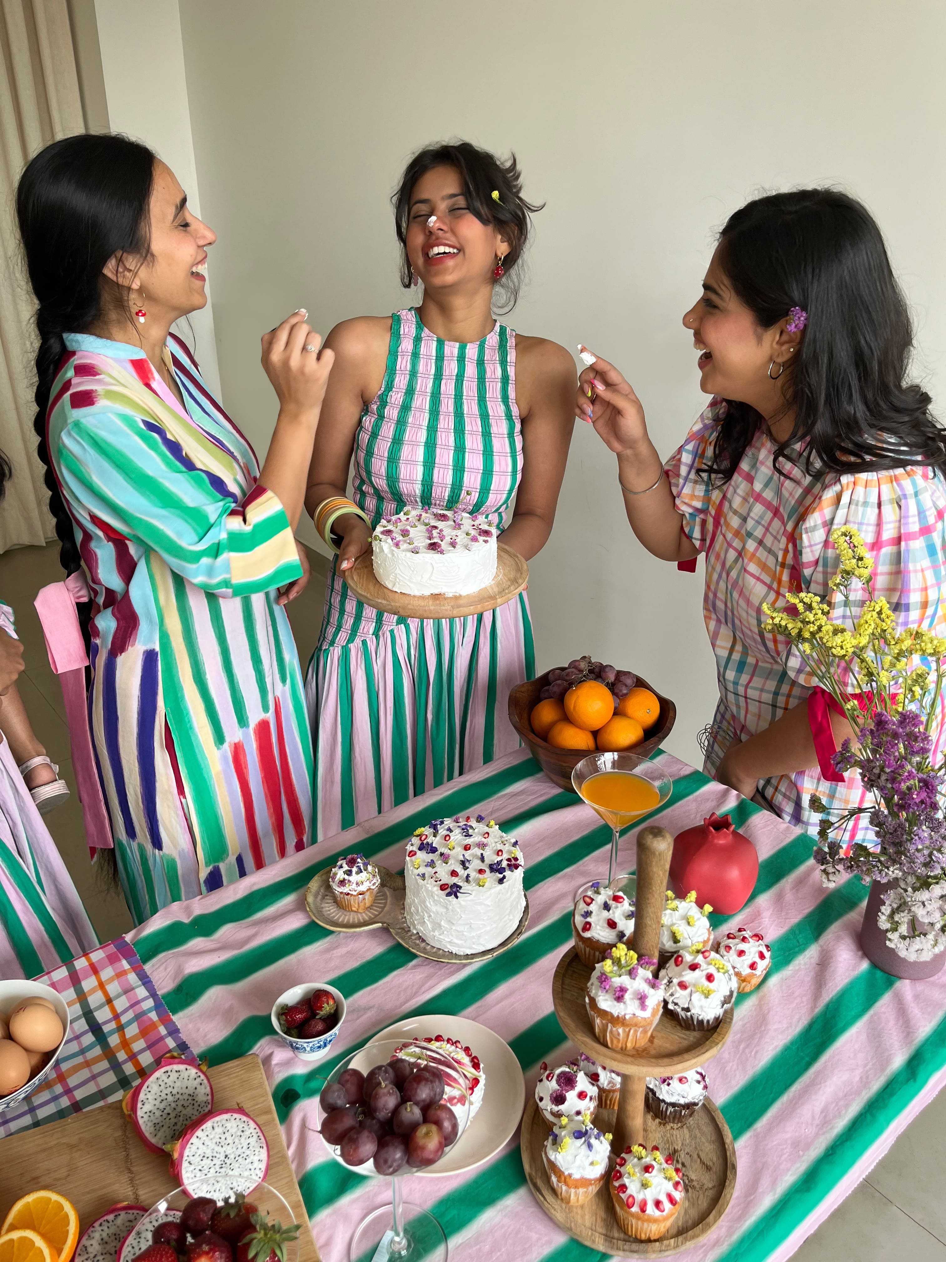 Three women celebrating a birthday wearing beautiful Imsoo dresses.